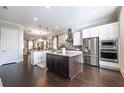 Bright, spacious kitchen with stainless steel appliances, island, and modern fixtures at 1384 Doublegate Dr, Brookhaven, GA 30319