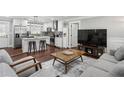 Inviting living room with hardwood floors, a comfortable sofa, and an adjacent modern, white kitchen at 1865 Lochlomand Se Ln, Smyrna, GA 30080