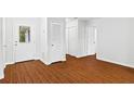 The entryway has wood floors, white walls, and multiple white doors at 2199 Summertown Dr, Norcross, GA 30071