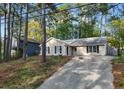 Inviting single-story home with a long driveway and serene setting amongst mature trees in a charming neighborhood at 2199 Summertown Dr, Norcross, GA 30071