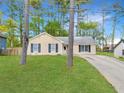 A single-story house with well maintained front lawn and mature trees at 2199 Summertown Dr, Norcross, GA 30071