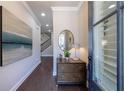 Inviting entryway with hardwood floors, elegant decor, and staircase to the upper level at 5010 Towneship Creek Rd, Roswell, GA 30075