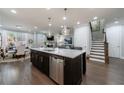 Spacious kitchen with stainless steel appliances, large island with barstools, and open view to dining and living areas at 5010 Towneship Creek Rd, Roswell, GA 30075