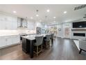 Open-concept kitchen featuring white cabinets, quartz countertops, stainless steel appliances, and a center island with seating at 5010 Towneship Creek Rd, Roswell, GA 30075
