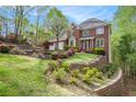 Beautiful brick home with a professionally landscaped front yard and retaining wall at 5145 Southlake Dr, Alpharetta, GA 30005