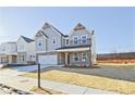 Charming two-story home featuring a brick and siding facade, covered porch, and manicured lawn at 4212 Adler Cir, Buford, GA 30519