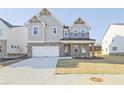 Two-story home featuring a brick and siding facade, a spacious driveway, and well-maintained landscaping at 4212 Adler Cir, Buford, GA 30519