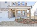 Inviting front porch with brick and wood columns, creating a warm entry to the home at 4212 Adler Cir, Buford, GA 30519