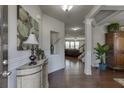 Inviting foyer featuring hardwood floors, elegant trim, and a glimpse into the open-concept living space at 4685 Orchard View Way, Cumming, GA 30028