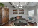 Cozy living room with coffered ceilings, hardwood floors, and decorative accents at 4685 Orchard View Way, Cumming, GA 30028