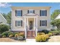 Inviting two-story home featuring an elegant front porch and professionally landscaped yard at 6463 Century Park Se Pl, Mableton, GA 30126