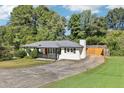 View of a well-maintained home featuring a driveway and a fenced backyard at 100 Charlotte Sw Dr, Mableton, GA 30126