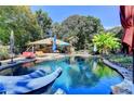 Relaxing backyard pool with lounge seating, surrounded by lush greenery and shade at 2962 Norman Cir, Duluth, GA 30096