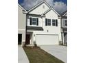 Charming exterior elevation featuring white siding, red front door, black shutters and a two car garage at 6324 Rosetta Drive, Lot 2, South Fulton, GA 30331