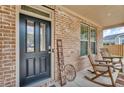Inviting front porch with rocking chairs and a 'Welcome' sign, showcasing the home's entrance at 1105 Alaska St, Hampton, GA 30228