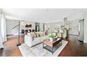 Open-concept living area with a comfortable sofa, modern decor, and an eat-in kitchen at 1276 Dahlgren Se Ln, Atlanta, GA 30316