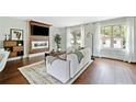 Bright living room featuring a modern fireplace, beautiful hardwood floors, and multiple windows at 1276 Dahlgren Se Ln, Atlanta, GA 30316