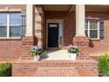 Close-up of front porch with elegant columns and potted plants, showcasing curb appeal at 132 Windmeadow Way, Fayetteville, GA 30214