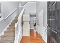 Bright foyer with hardwood floors, staircase, and view into dining area creating an inviting entrance at 2155 Westwind Dr, Roswell, GA 30075