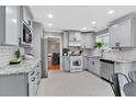 Stylish kitchen featuring granite countertops, stainless steel appliances, and modern cabinetry at 2155 Westwind Dr, Roswell, GA 30075