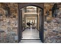 Grand foyer showcasing a marble floor, stone walls, and an open view to the piano room at 3053 Cambridge Hill Dr, Dacula, GA 30019