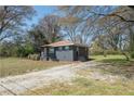 Exterior angle showing gravel driveway and side view of charming home at 5085 Lake Dr, Forest Park, GA 30297