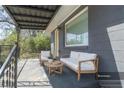 Virtually staged front porch with seating, inviting outdoor relaxation at 5085 Lake Dr, Forest Park, GA 30297