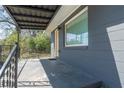 Inviting covered front porch with metal railing and ample space at 5085 Lake Dr, Forest Park, GA 30297