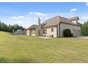 Spacious backyard featuring a well-maintained lawn, patio area, and the home's exterior with a visible garage at 1246 Foxcreek Dr, Mcdonough, GA 30252
