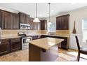 Well-appointed kitchen with dark wood cabinetry, granite countertops, stainless steel appliances, and a central island at 1246 Foxcreek Dr, Mcdonough, GA 30252