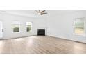 Spacious living room with fireplace, ceiling fan, and views to the outdoors at 2528 Morgan Chase Dr, Buford, GA 30519