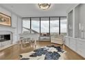 Bright living room featuring a white baby grand piano, fireplace, and panoramic city views at 2828 Peachtree Nw Rd # 3100, Atlanta, GA 30305