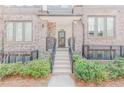 Townhome entrance with brick facade, stairs, and neatly trimmed greenery at 379 Pratt Se Dr # 408, Atlanta, GA 30315