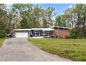 Lovely home exterior with a spacious front lawn, brick details, and attached garage at 1185 Winterberry Ct, Lawrenceville, GA 30043