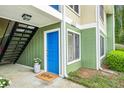 Home entrance with a vibrant blue door, 'Welcome' mat, and potted plants creating an inviting entryway at 1255 Branch Dr, Tucker, GA 30084