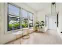 Bright sunroom filled with natural light from many windows and decorated with plants and seating at 1255 Branch Dr, Tucker, GA 30084