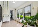 Bright sunroom filled with natural light from many windows and decorated with plants and seating at 1255 Branch Dr, Tucker, GA 30084