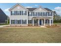 Attractive two-story house with blue shutters, a covered porch, and expansive front lawn at 156 Marchmont Dr, Locust Grove, GA 30248