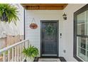 Welcoming front porch featuring a stylish door with a wreath and potted plants at 770 Reed Se St, Atlanta, GA 30315