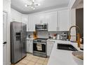 Well-appointed kitchen featuring stainless steel appliances, white cabinets, and quartz countertops at 1850 Cotillion Dr # 2221, Atlanta, GA 30338