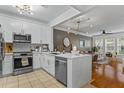 Modern kitchen featuring white cabinets, stainless steel appliances, and an island with quartz countertops at 1850 Cotillion Dr # 2221, Atlanta, GA 30338
