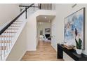 Inviting entryway featuring a staircase with modern railing and a view into the adjacent living room at 3286 Sir Henry St, Atlanta, GA 30344