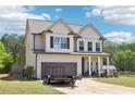 Beautiful two-story home with a well-manicured lawn, attached garage, and an inviting front porch at 103 Cottage Way, Euharlee, GA 30145