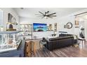 Comfortable living room featuring a fireplace, lots of light, and a sleek black couches at 103 Cottage Way, Euharlee, GA 30145