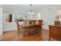 Formal dining room features hardwood floors, chandelier lighting, and ample seating for six at 6851 Roswell Rd # D-6, Atlanta, GA 30328