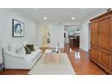 Inviting living room with hardwood floors and views into the dining room and hallway at 6851 Roswell Rd # D-6, Atlanta, GA 30328