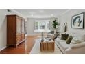 Cozy living room with hardwood floors, a bay window, and a comfortable seating area at 6851 Roswell Rd # D-6, Atlanta, GA 30328