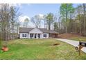 Charming one-story home with a covered front porch, well-manicured lawn, and a convenient carport at 121 Tricias Way, Temple, GA 30179