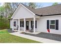 Inviting front porch with rocking chairs and charming details, enhancing the home's curb appeal at 121 Tricias Way, Temple, GA 30179
