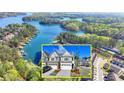 Picturesque aerial view of waterfront homes with lake access and lush green trees at 2220 Lanier Harbor Pt, Buford, GA 30518